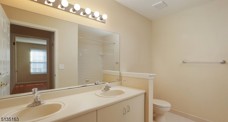 250 Potomac Drive Bernards, NJ 07920 - Photo 16 of 22 a bathroom with a granite countertop sink a toilet and a mirror