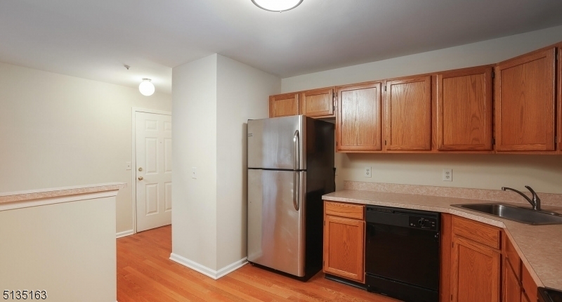 250 Potomac Drive Bernards, NJ 07920 - Photo 6 of 22 a kitchen with stainless steel appliances granite countertop a refrigerator and a sink
