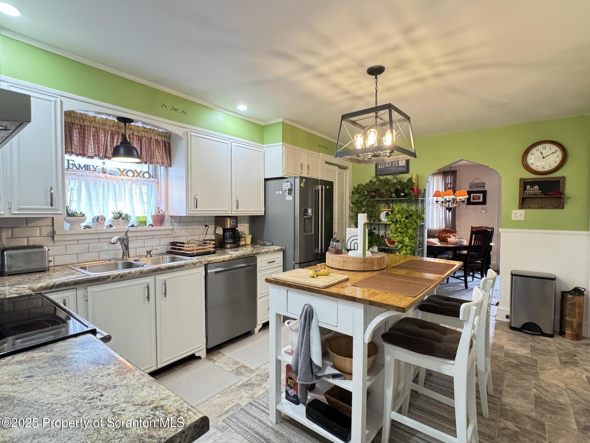 954 Lattimer Road Hazleton, PA 18202 - Photo 8 of 16 a kitchen with stainless steel appliances granite countertop a sink stove and refrigerator
