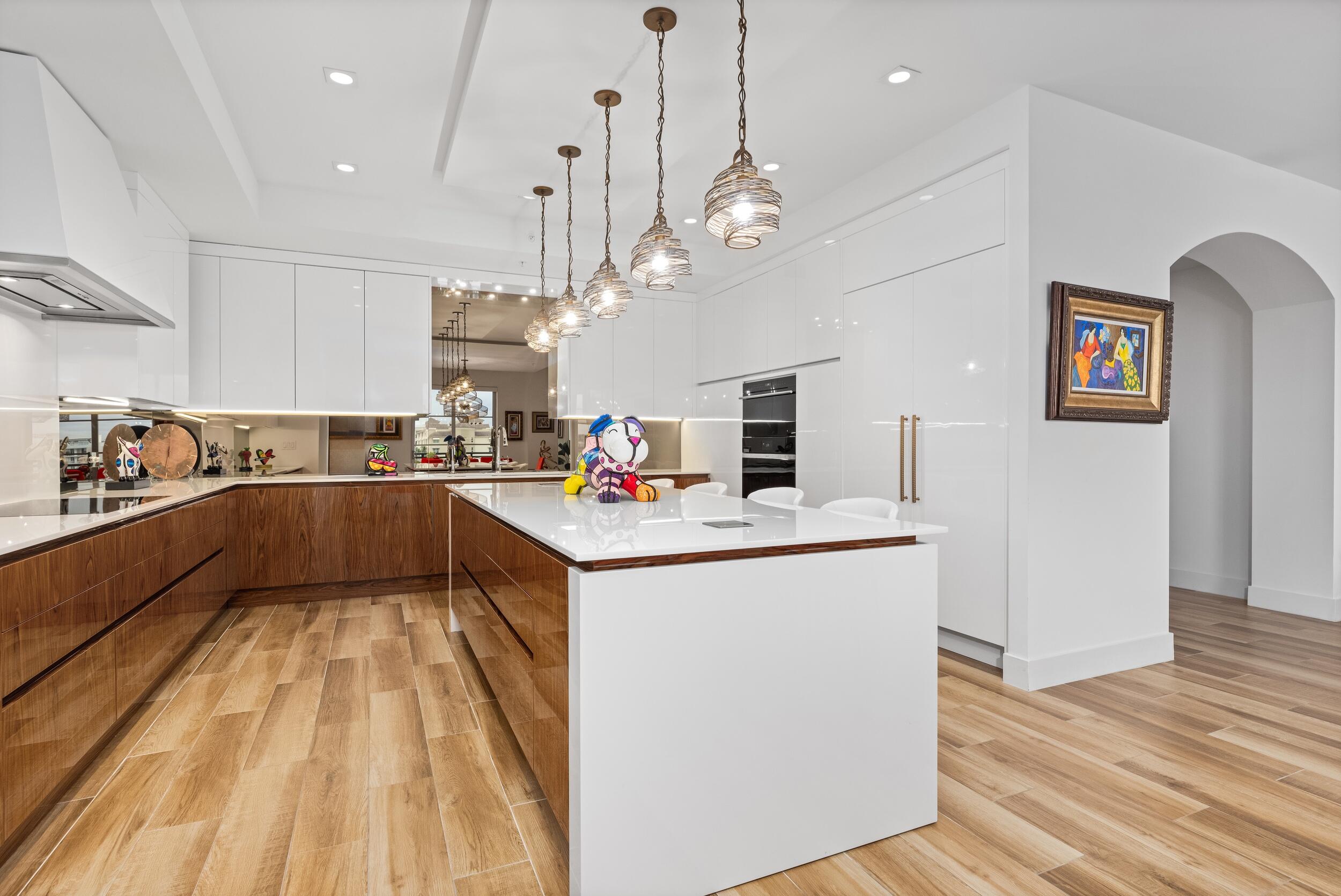 155 East Boca Raton Road, Unit 812 Boca Raton, FL 33432 - Photo 17 of 54 a kitchen with kitchen island granite countertop stainless steel appliances sink and wooden floor