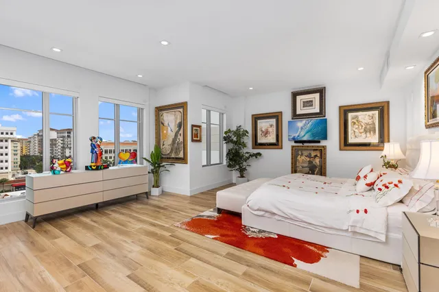 a bedroom with a bed and a large mirror