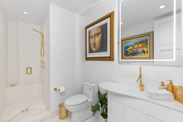 a bathroom with a toilet a sink and a bath tub