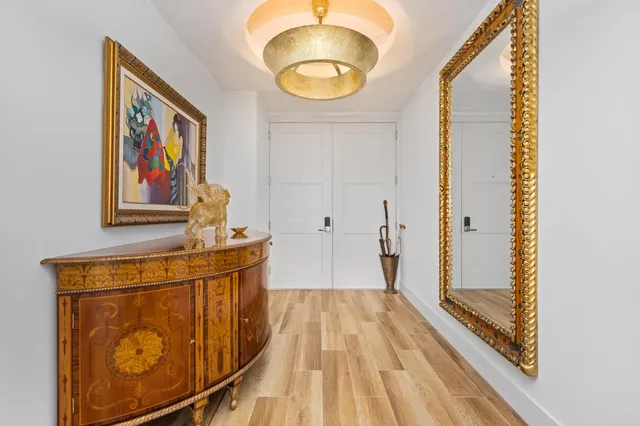 a view of a hallway with wooden floor and entryway