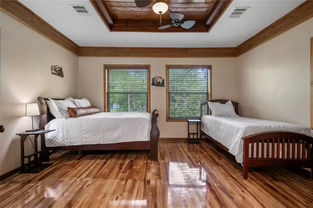 a bed sitting in a bedroom next to a window