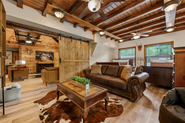 a living room with furniture a fireplace and a table