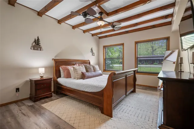 a bedroom with a bed and a large window