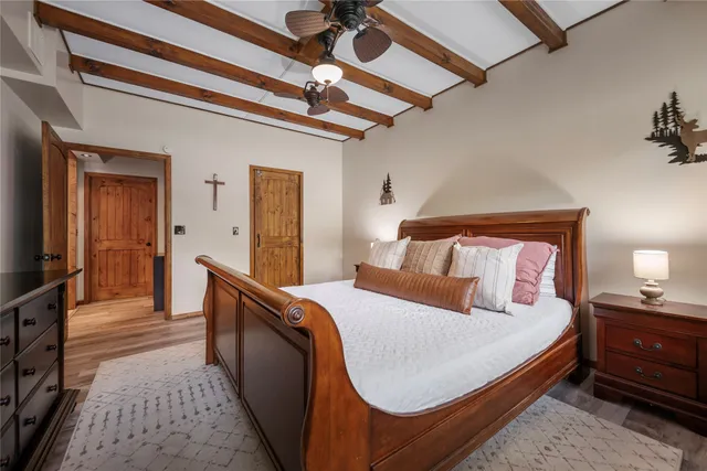 a bedroom with a bed and a mirror on dresser