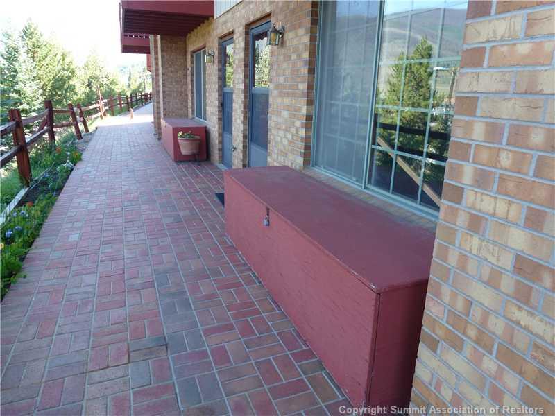 70 Evergreen Road, Unit 104 Dillon, CO 80435 - Photo 2 of 22 a view of a backyard with brick wall and a potted plant