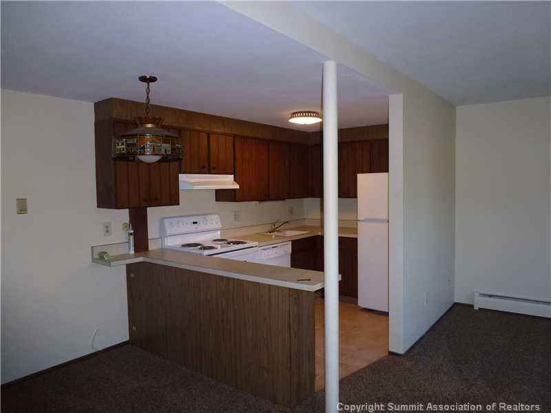 70 Evergreen Road, Unit 104 Dillon, CO 80435 - Photo 5 of 22 a kitchen with a refrigerator and a stove top oven