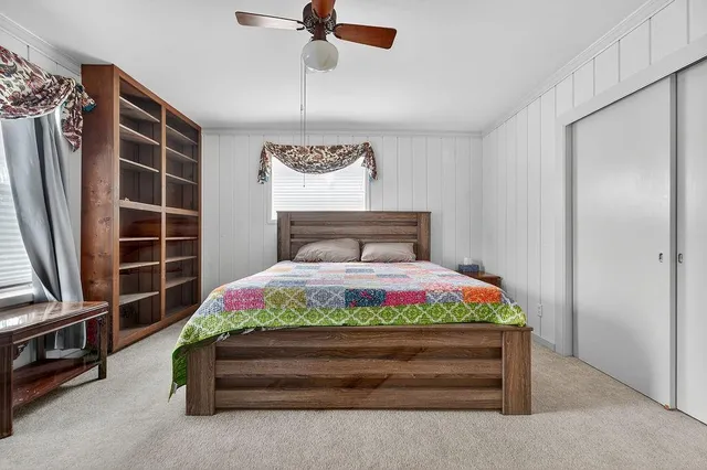 a kitchen with stainless steel appliances granite countertop a refrigerator a sink dishwasher a stove oven and a dining table with wooden floor