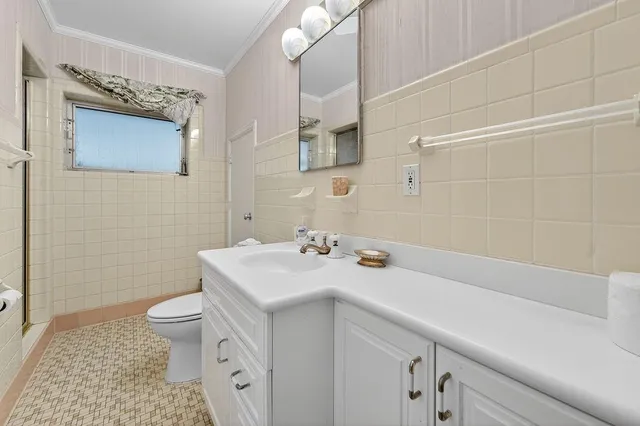 a large kitchen with kitchen island a sink stainless steel appliances and cabinets