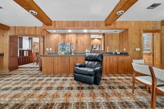 a view of a hallway with a white walls and a window