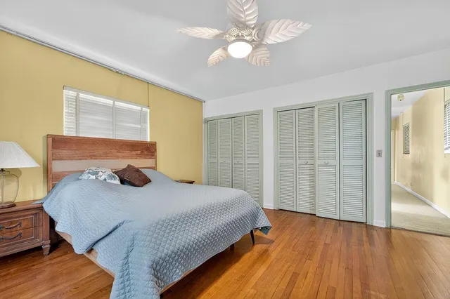 a view of a green field with trees in the background