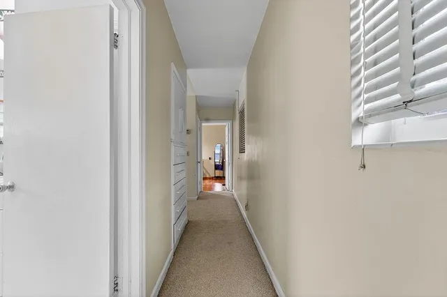 an aerial view of residential houses with outdoor space and trees