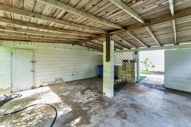an aerial view of a house with a yard and large tree