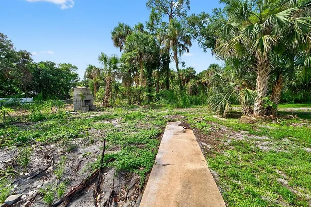 an aerial view of a house with a yard and garden space