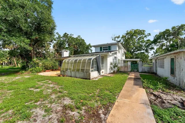 an aerial view of a house with outdoor space and street view