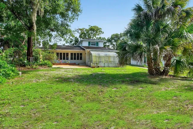 a view of a house with a backyard space