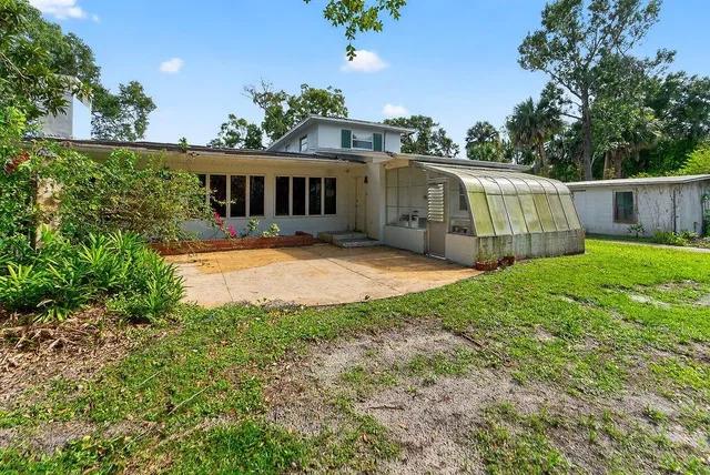 an aerial view of house with yard and entertaining space