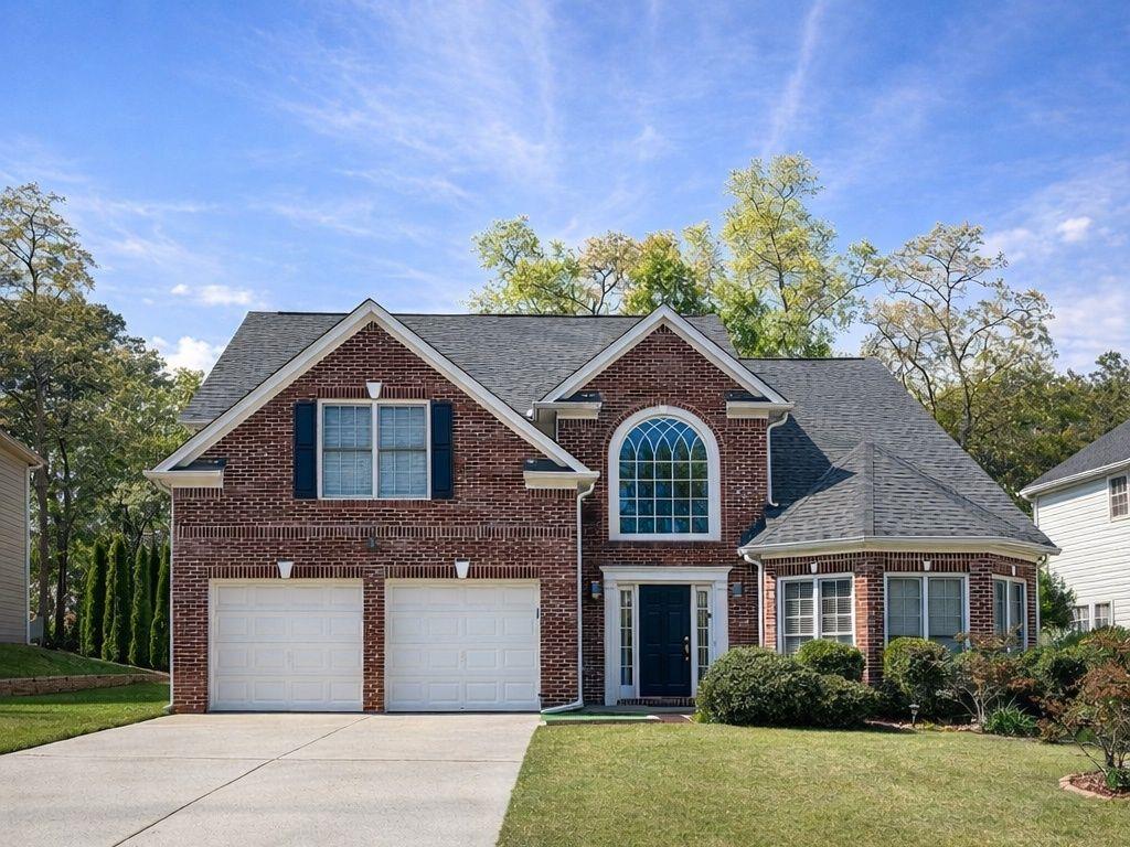 239 Sweet Cane Trail Grayson, GA 30017 - Photo 1 of 30 a front view of a house with a yard and garage