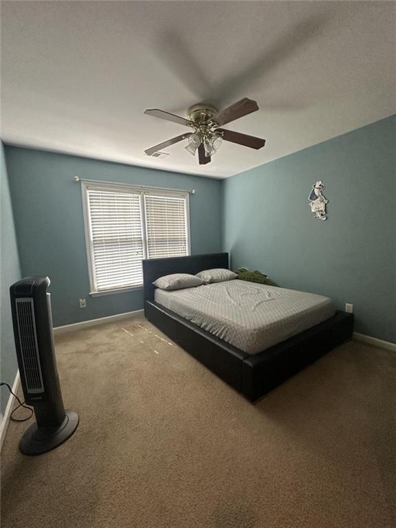 239 Sweet Cane Trail Grayson, GA 30017 - Photo 26 of 30 a bedroom with a bed a dresser and a window