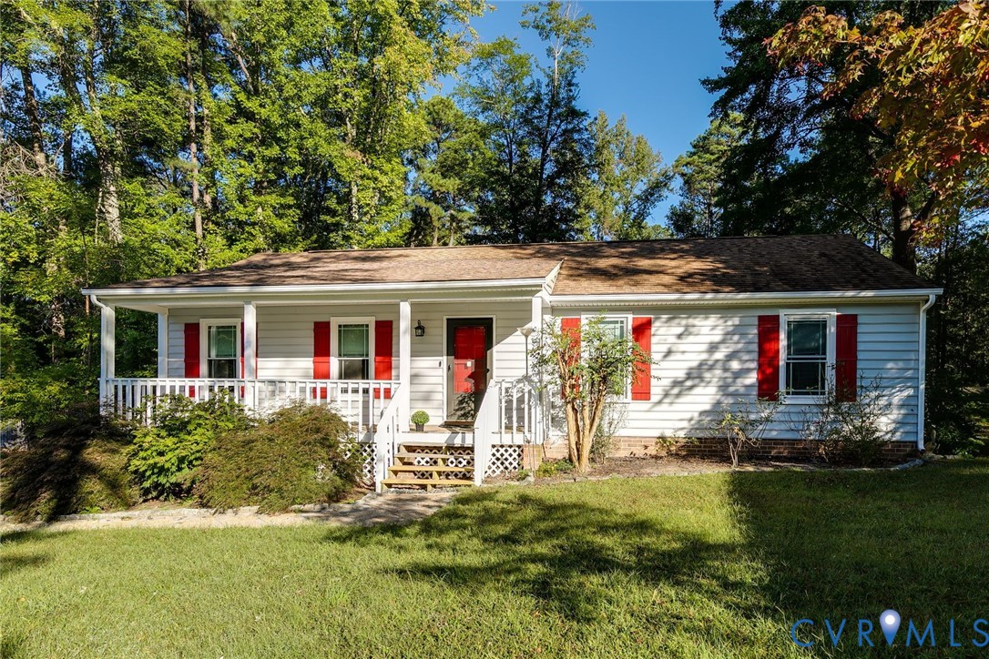 Ranch-style home featuring covered porch and a fro
