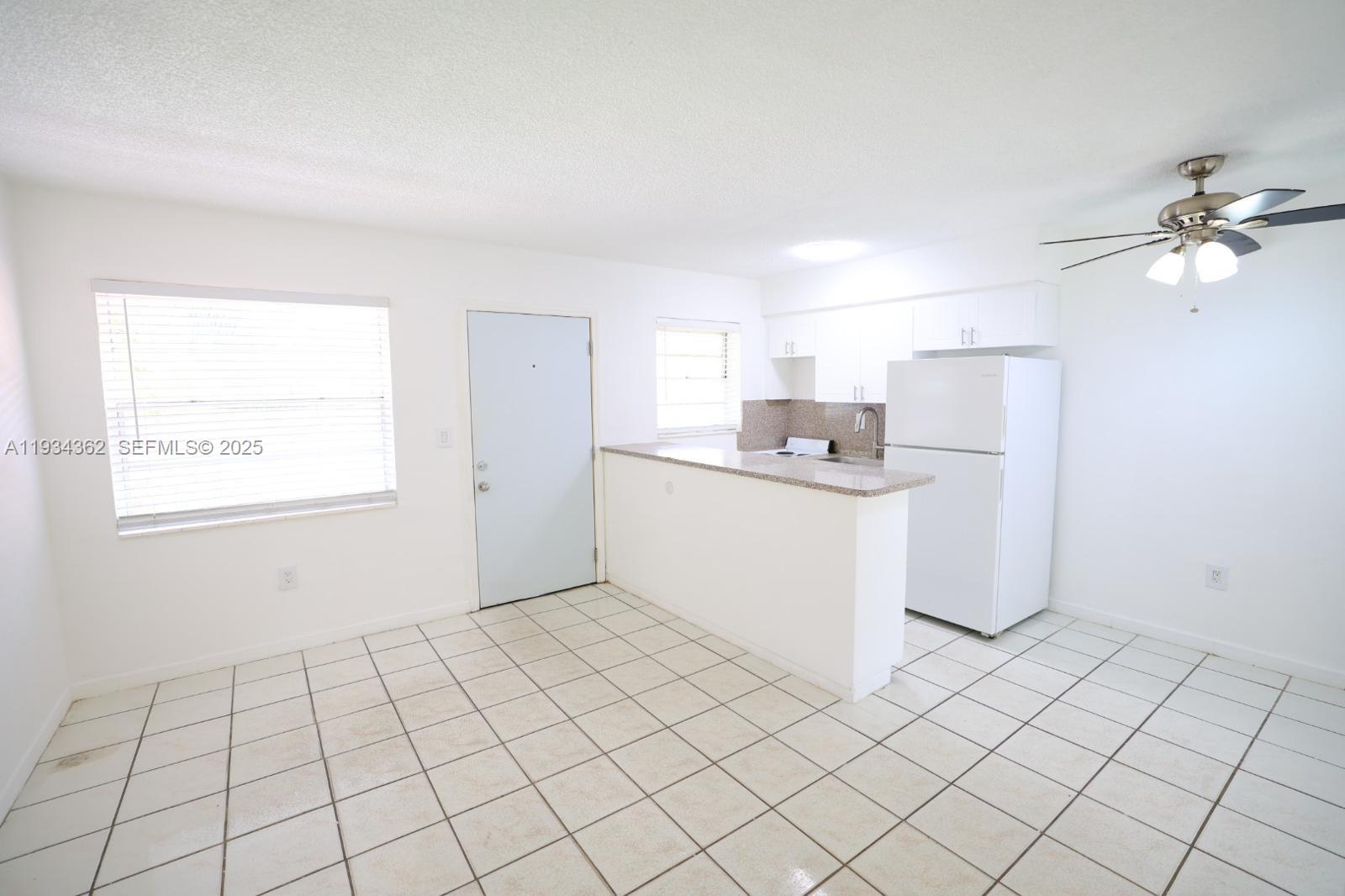 7155 West 14th Court, Unit 17 Hialeah, FL 33014 - Photo 5 of 12 a kitchen with a sink cabinets and window