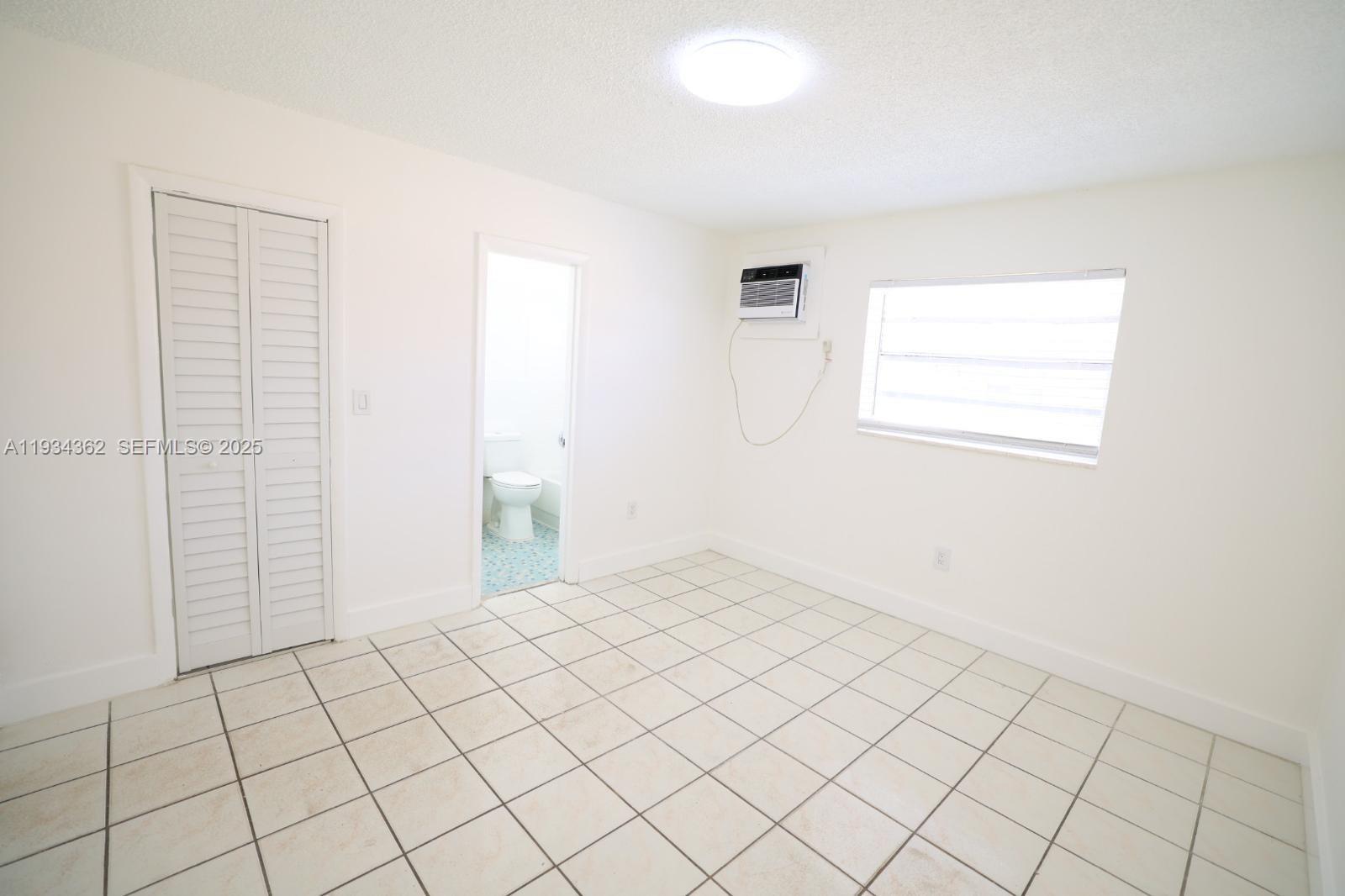 7155 West 14th Court, Unit 17 Hialeah, FL 33014 - Photo 8 of 12 a view of an empty room and window
