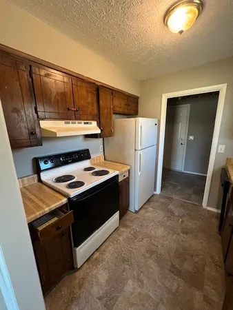 a kitchen with a stove and a refrigerator