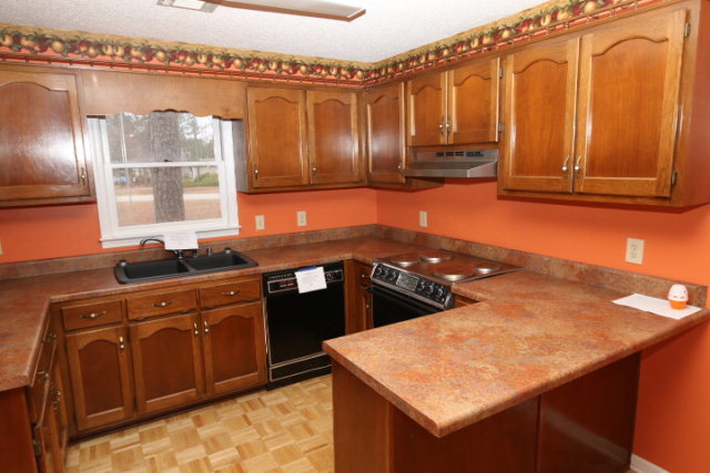 140 Timber Ridge Drive Macon, GA 31216 - Photo 10 of 15 a kitchen with stainless steel appliances granite countertop a sink stove and cabinets