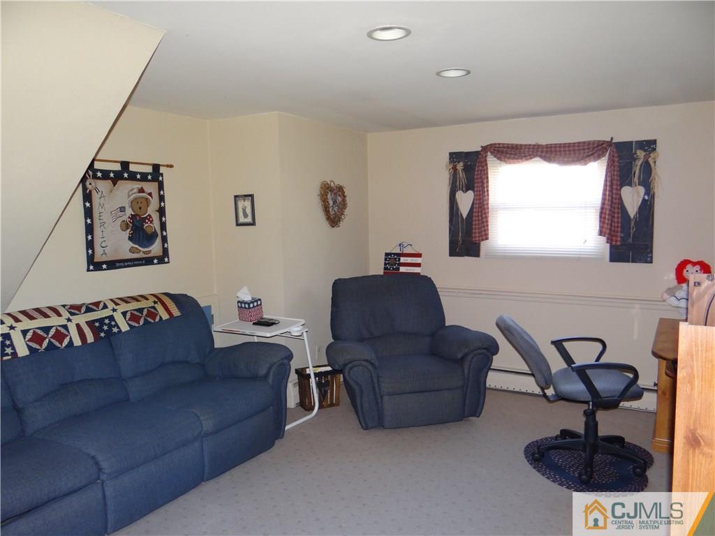16 Baldwin Road Edison, NJ 08817 - Photo 6 of 12 a living room with a couch and a rug