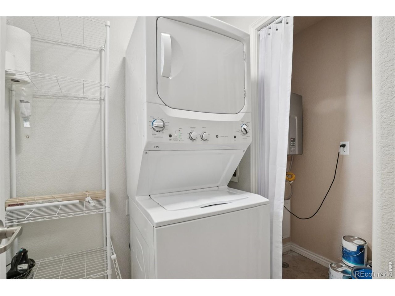 727 Rawlins Way Lafayette, CO 80026 - Photo 23 of 27 Laundry room with space-saving stackable washer and dryer (included with home!)