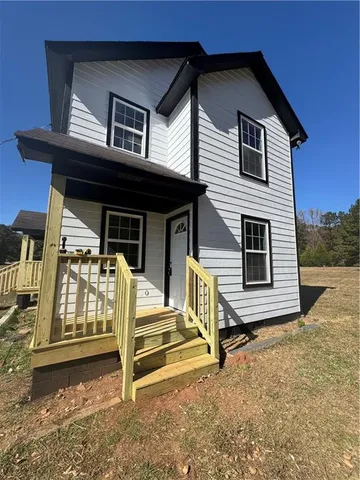 a view of a house with wooden walls and stairs