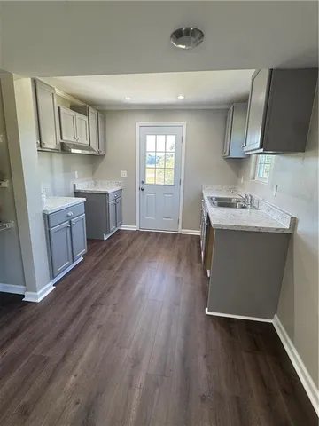 a kitchen with stainless steel appliances wooden floors and wooden cabinets
