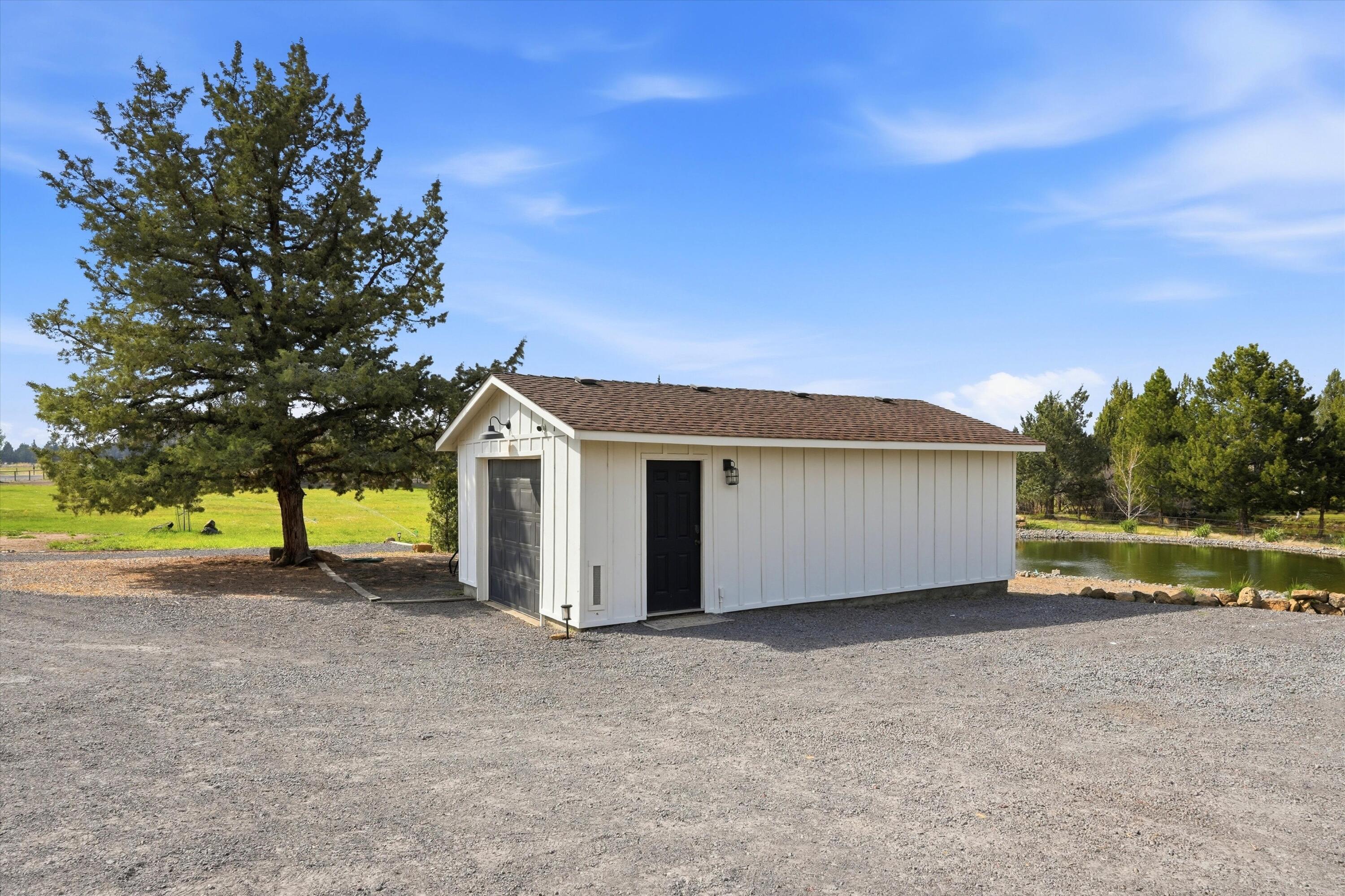 61280 Larsen Road Bend, OR 97702 - Photo 43 of 58 a view of a house with a yard and large tree