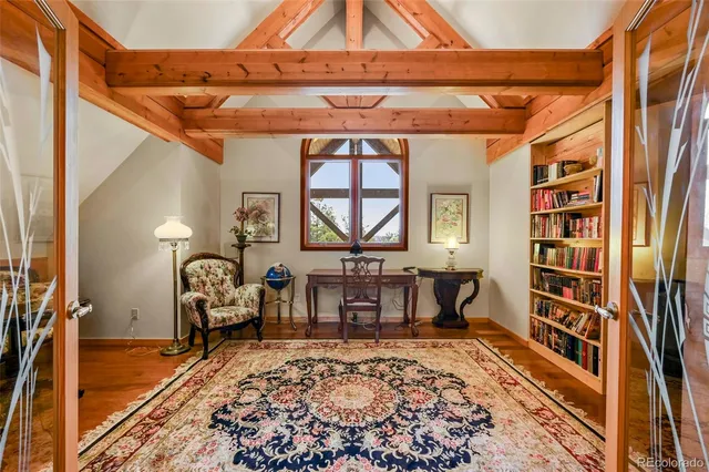 a bedroom with two beds and large windows