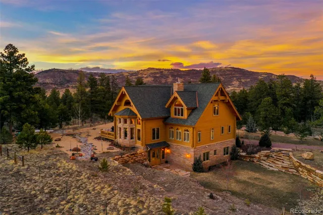 a aerial view of a house with a mountain in the background