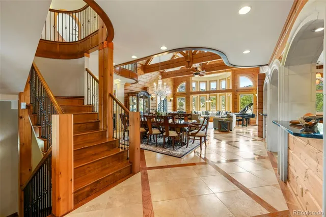 a view of a hallway with a couch and chandelier