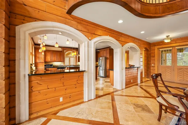 a kitchen with stainless steel appliances granite countertop a stove and a large window