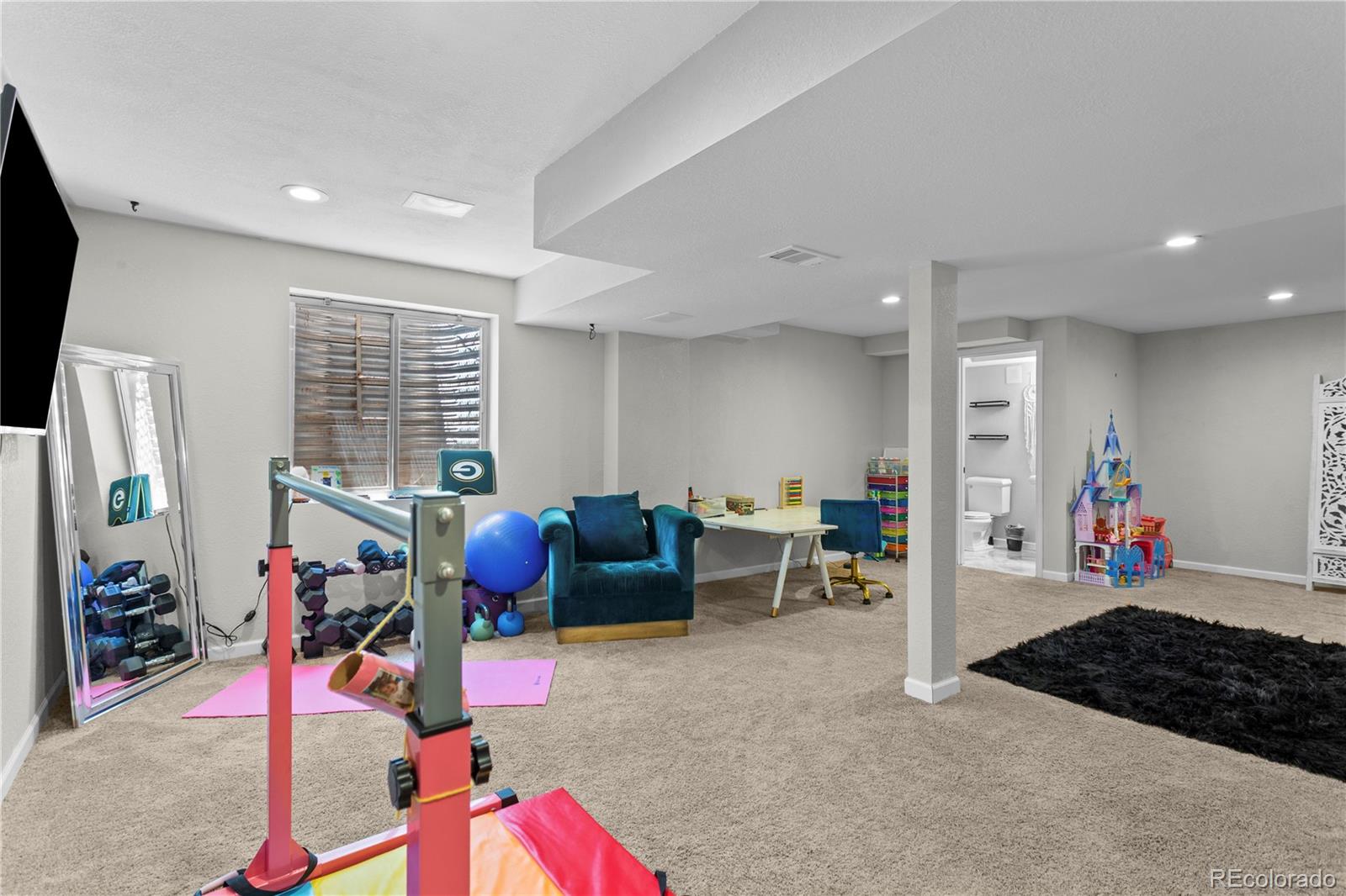 2212 Hyacinth Road Littleton, CO 80129 - Photo 38 of 44 a bedroom with furniture and a gym equipment