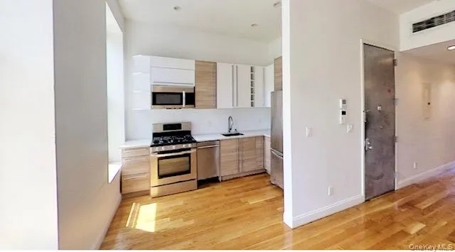 a kitchen with a refrigerator and a stove top oven