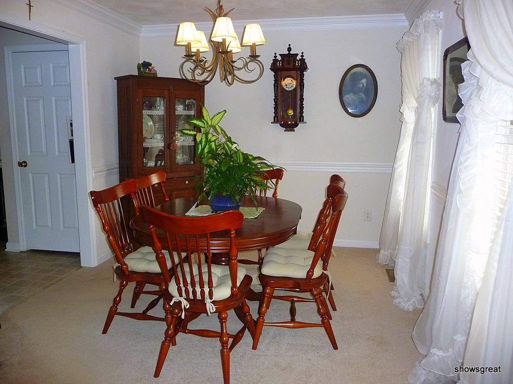 1770 Meadows Road Vinton, VA 24179 - Photo 2 of 37 a dining room with furniture and a clock