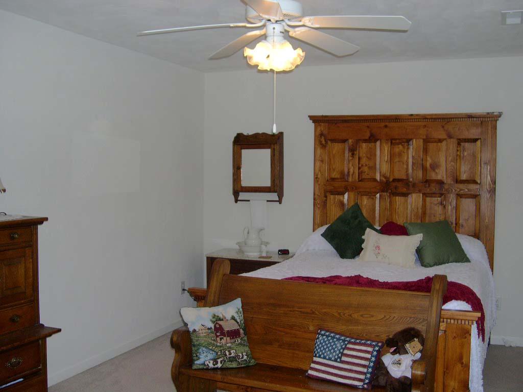 1770 Meadows Road Vinton, VA 24179 - Photo 22 of 37 a bedroom with a bed and a chandelier