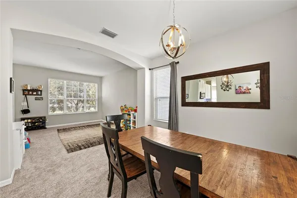 a dining area with furniture and a bed