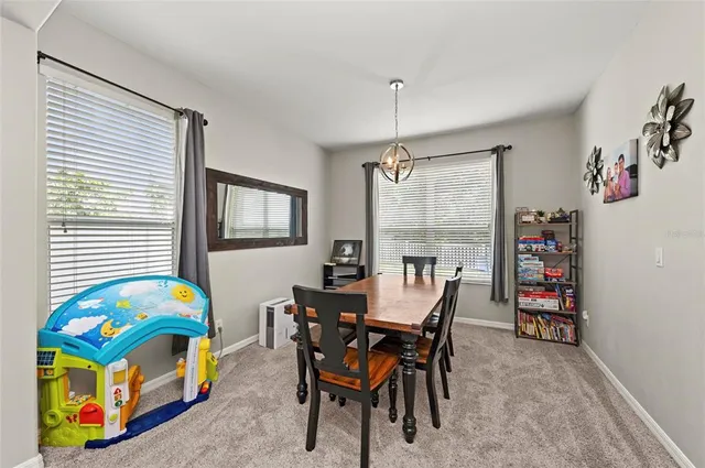a dining room with furniture and window