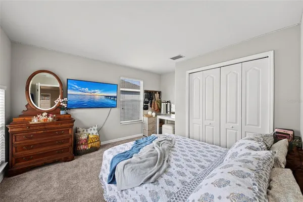 a bedroom with a bed and a dresser