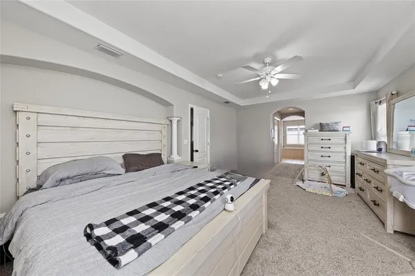 a bathroom with a tub a sink a mirror and a shower