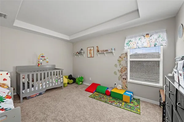 a living room with furniture and a piano