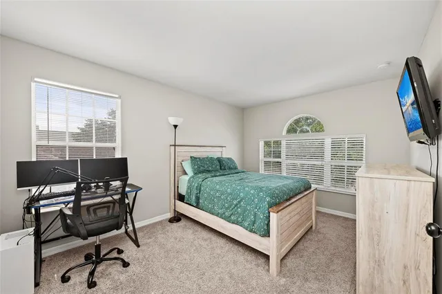 a bed room with a bed and a desk