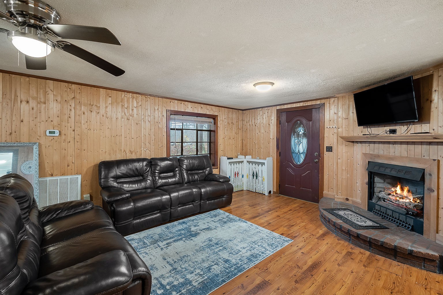 394 Dale Ridge Road Dowelltown, TN 37059 - Photo 8 of 32 a living room with furniture a flat screen tv and a fireplace